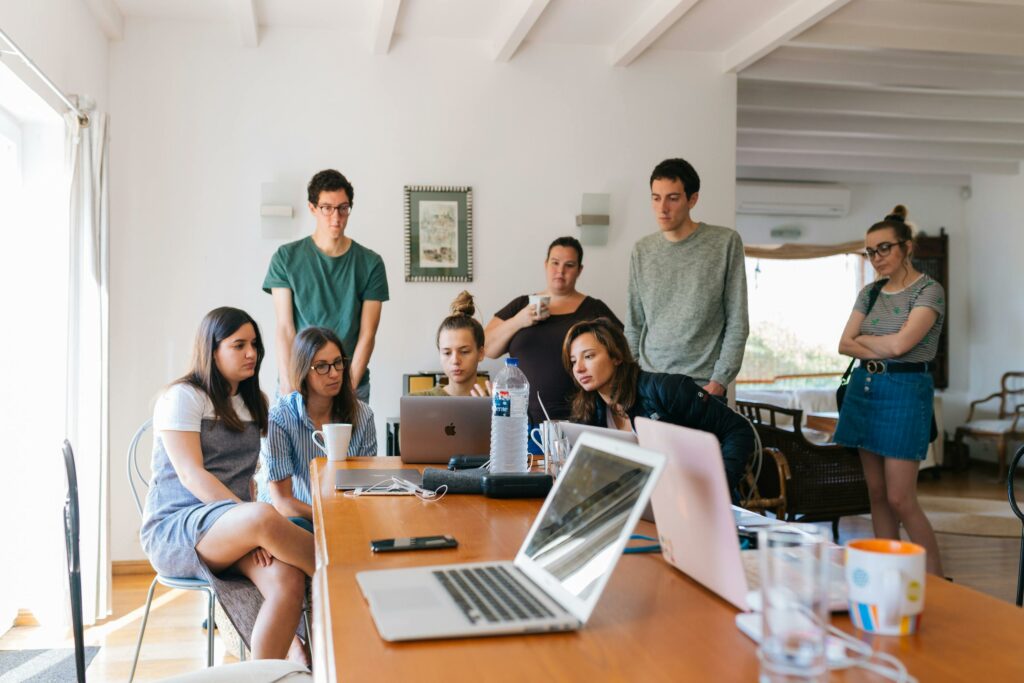 Group of young professionals engaged in a collaborative meeting in a modern office setting.